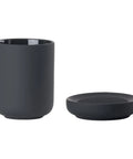Black toothbrush mug and soap dish on a white background.