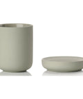 Light green toothbrush mug and soap dish on a white background
