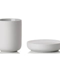 Light gray ceramic cup and soap dish on a white background