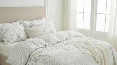 Bed with floral bedding in a bright bedroom