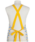 Yellow apron with floral pattern on a mannequin against a white background