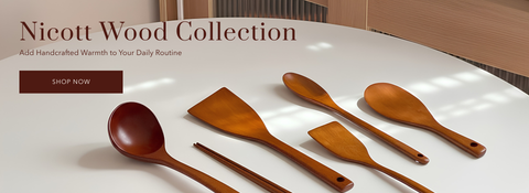 A set of six handcrafted wooden kitchen utensils, including two spoons, two spatulas, and a chopstick, displayed on a white table with a warm wood background. Text on the left reads 'Nicott Wood Collection' with a 'SHOP NOW' button.