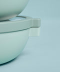 Close up image of round green food containers stacked on top of each other